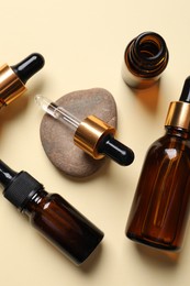 Photo of Flat lay composition with face serums on beige background