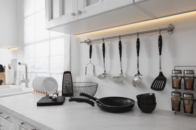 Set of different utensils on countertop in kitchen