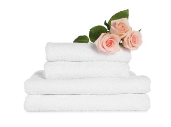 Photo of Stack of clean soft towels with flowers isolated on white