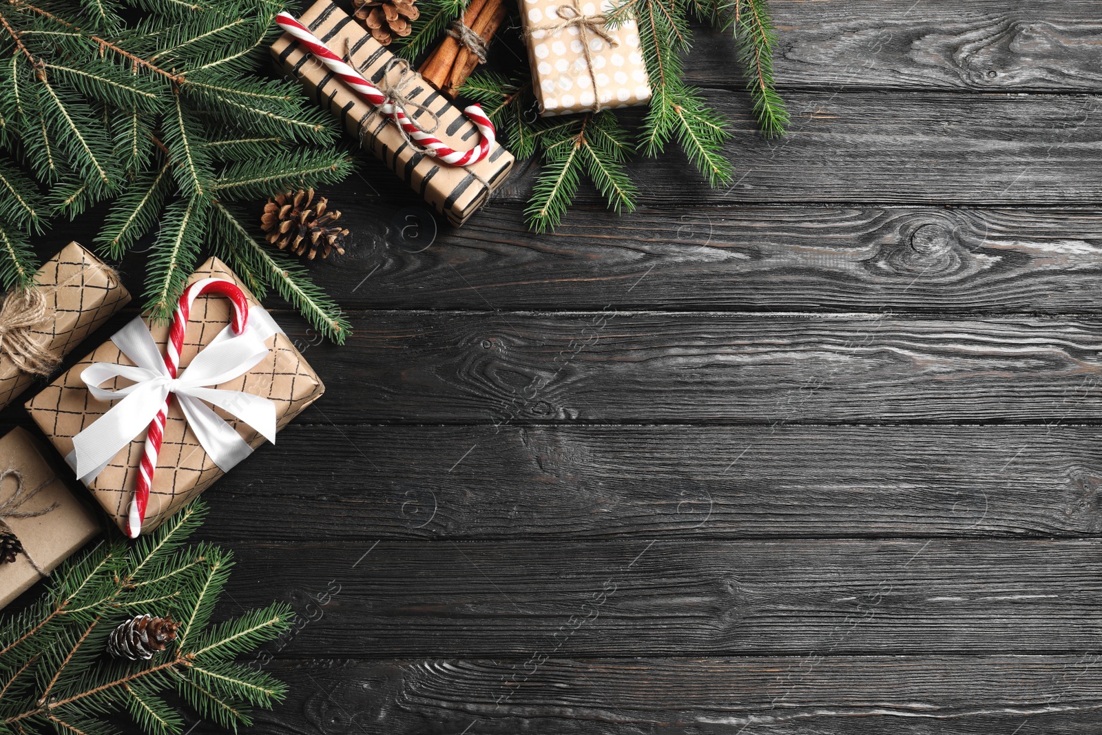 Photo of Flat lay composition with Christmas gift boxes and fir branches on wooden background