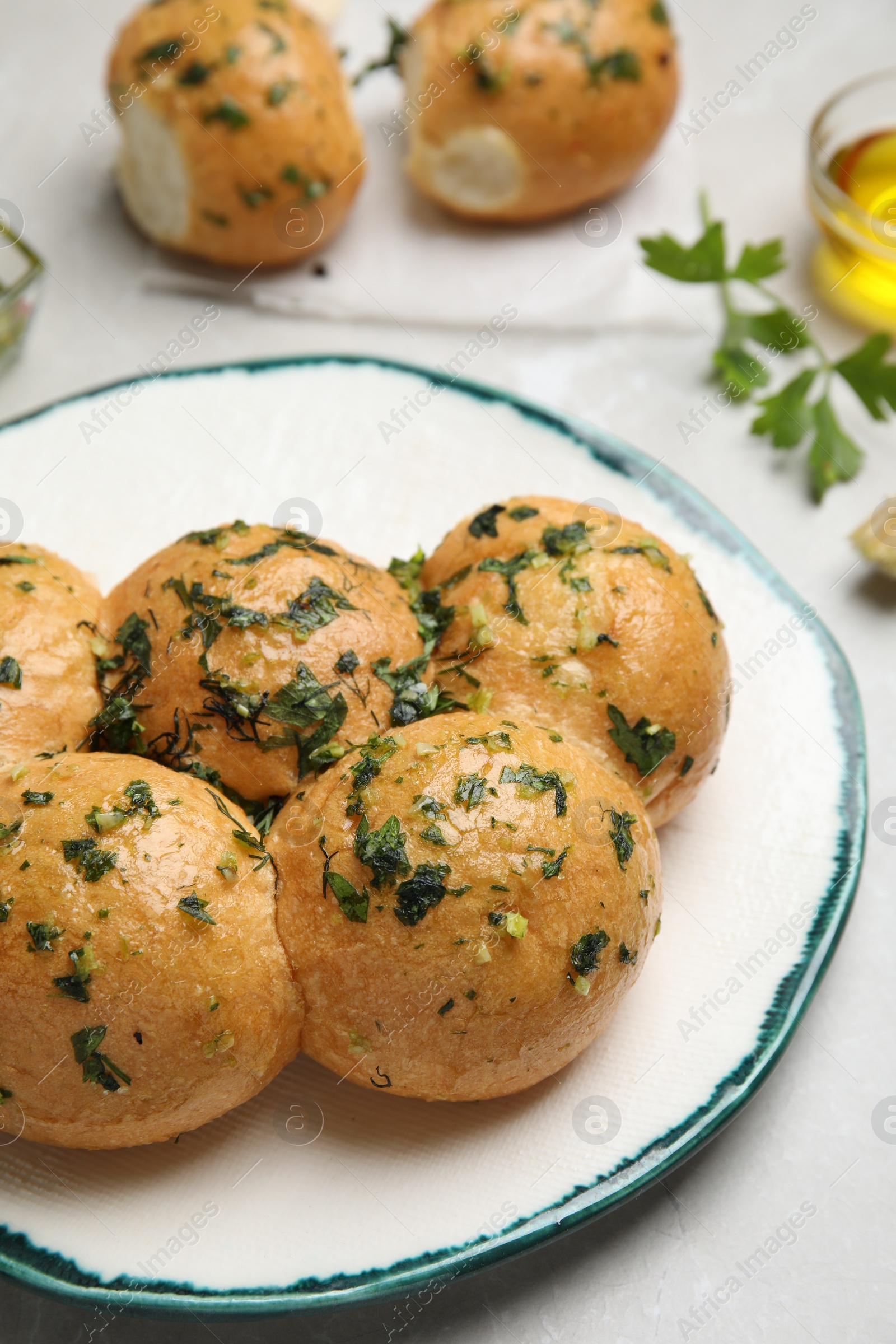 Photo of Traditional Ukrainian bread (Pampushky) with garlic on light table