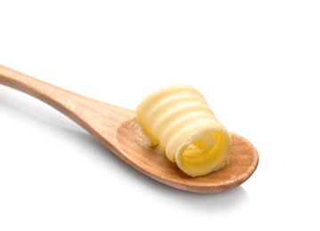 Wooden spoon with butter curl on white background