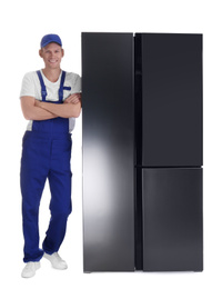 Professional worker near refrigerator on white background