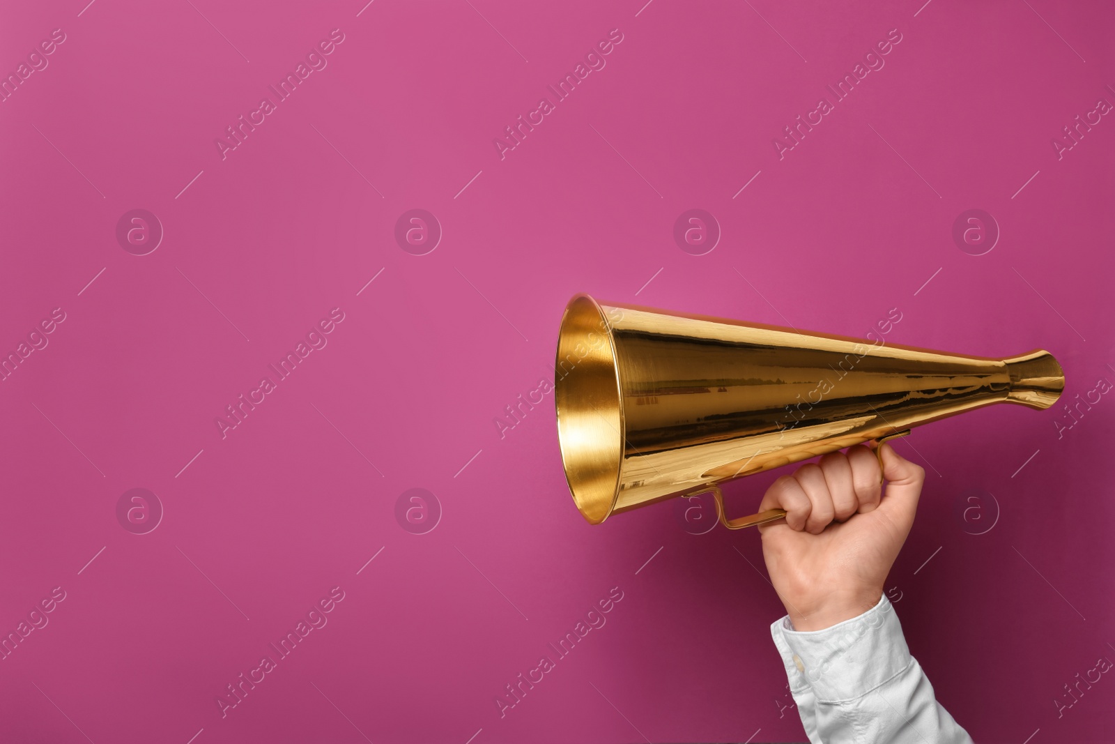 Photo of Man holding megaphone on color background