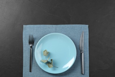 Photo of Stylish setting with elegant cutlery on grey textured table, top view