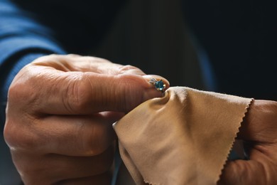 Photo of Professional jeweler working with ring, closeup view