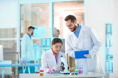 Young scientists working in laboratory. Chemical analysis