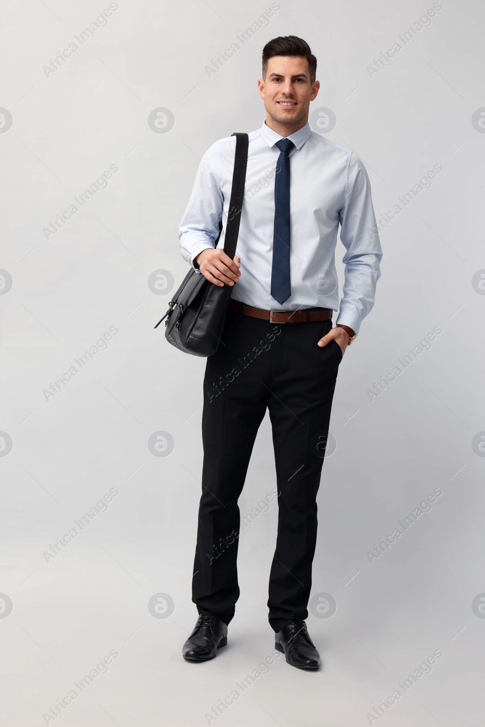 Photo of Businessman with stylish leather briefcase on light background