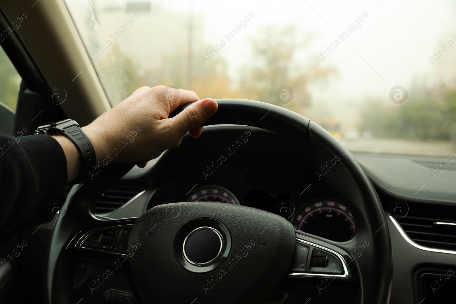 Photo of Man driving his car, closeup. Traffic rules