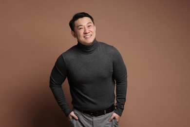 Portrait of happy man on brown background