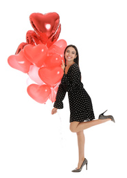 Beautiful young woman with heart shaped balloons isolated on white. Valentine's day celebration