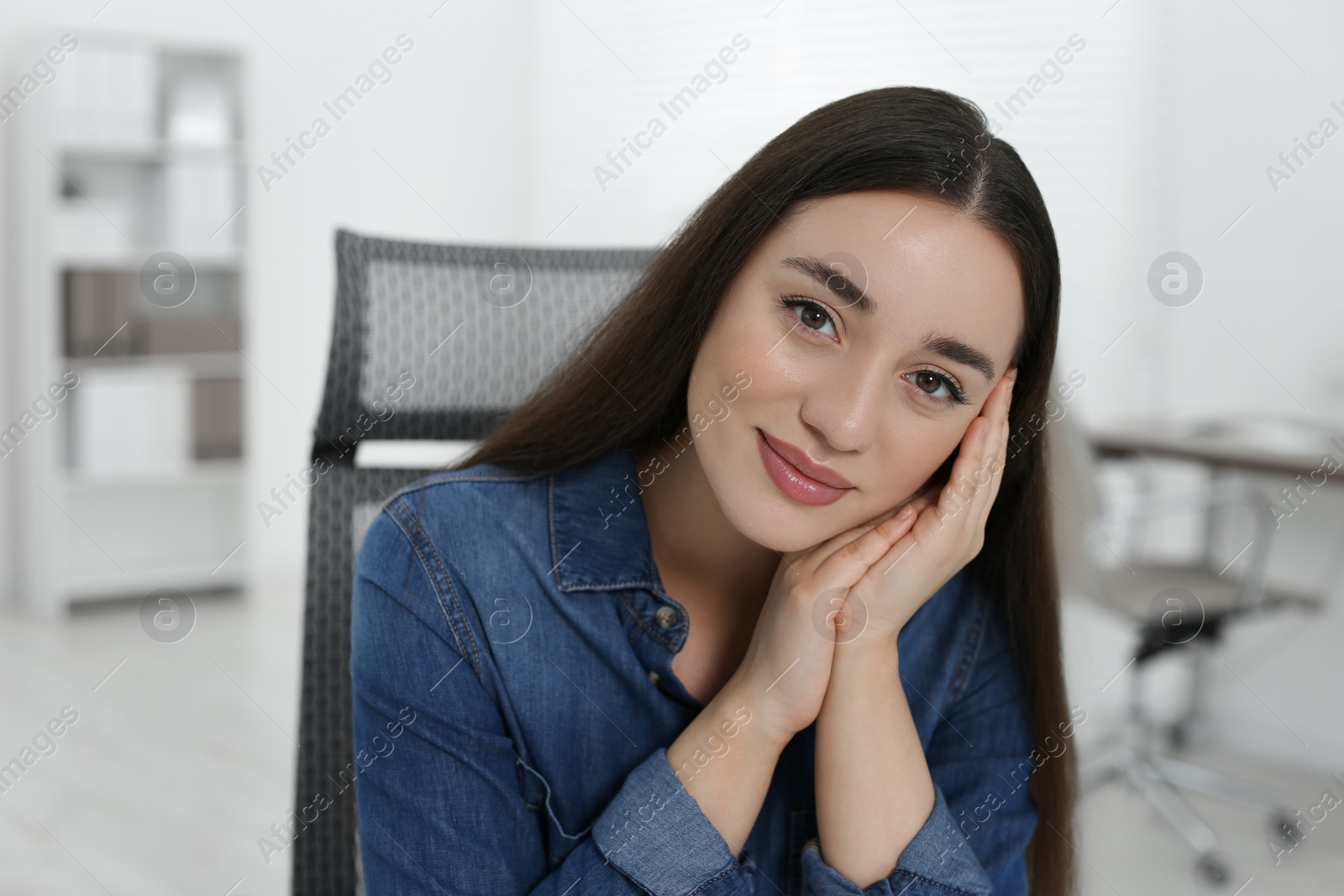 Photo of Portrait of beautiful young woman in office