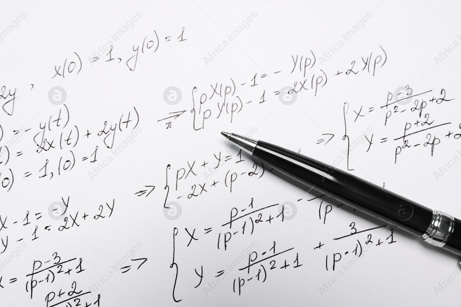 Photo of Sheet of paper with mathematical formulas and pen, closeup