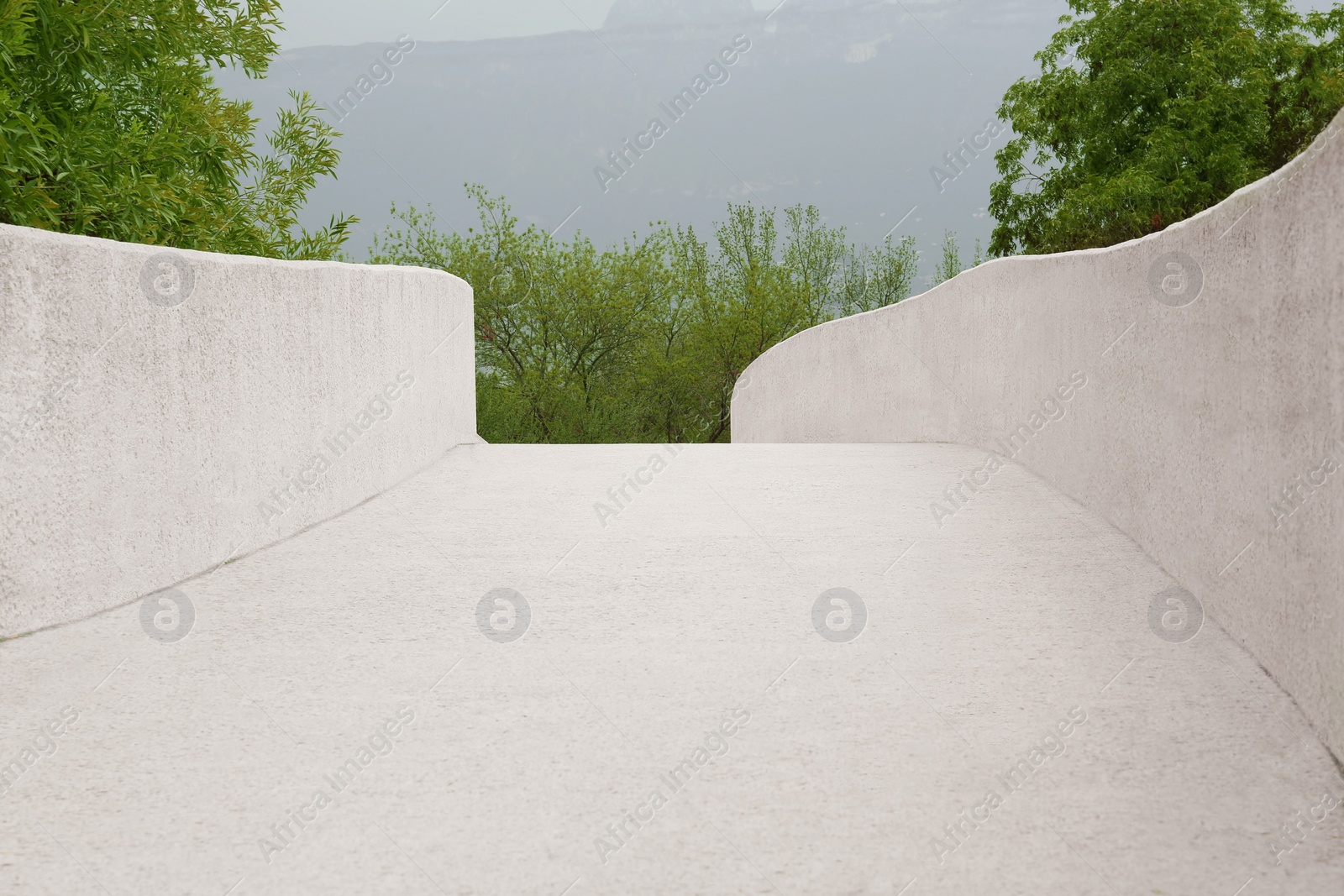 Photo of Big concrete handrailings near beautiful trees outdoors