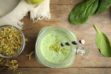 Photo of Green buckwheat smoothie on wooden table, top view