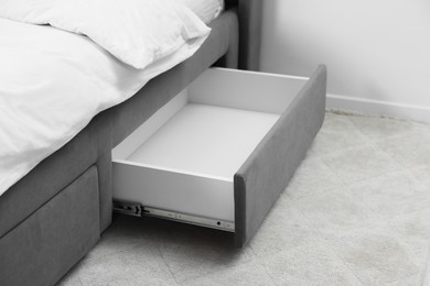 Photo of Storage drawer for bedding under modern bed in room