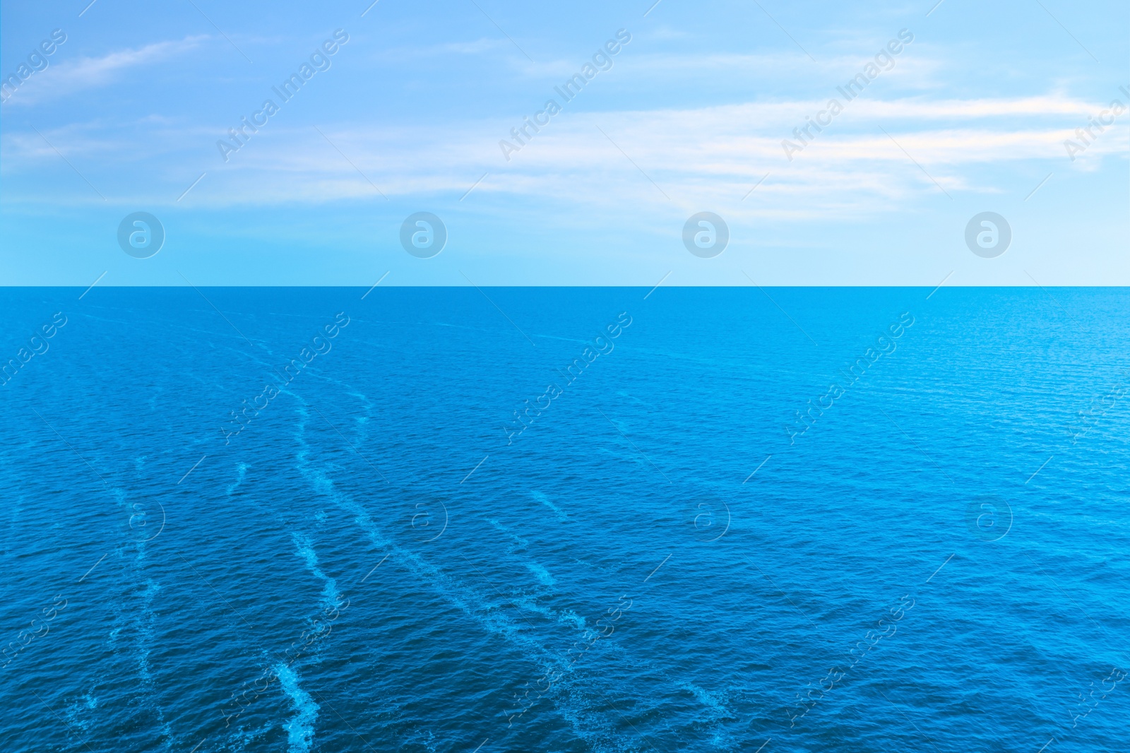 Image of Beautiful ripply sea under blue sky with clouds