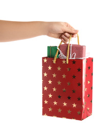 Photo of Woman holding shopping paper bag with presents on white background, closeup