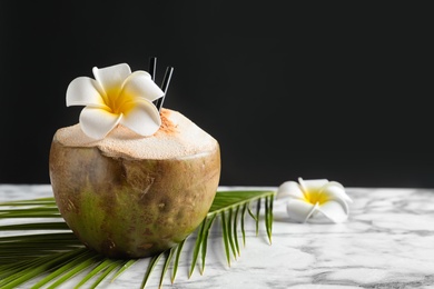 Fresh green coconut on table against dark background