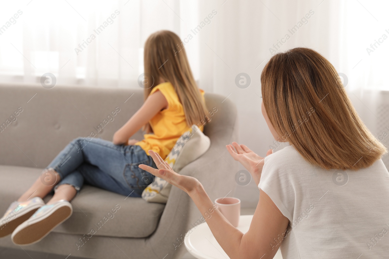 Photo of Mother scolding her teenager daughter at home