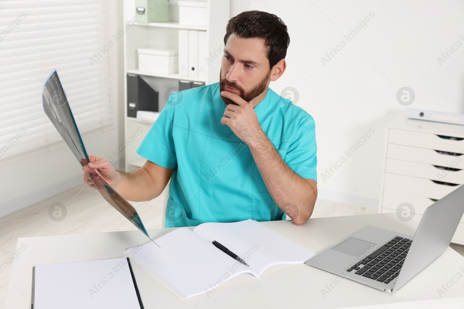 Photo of Doctor examining neck MRI scan in hospital