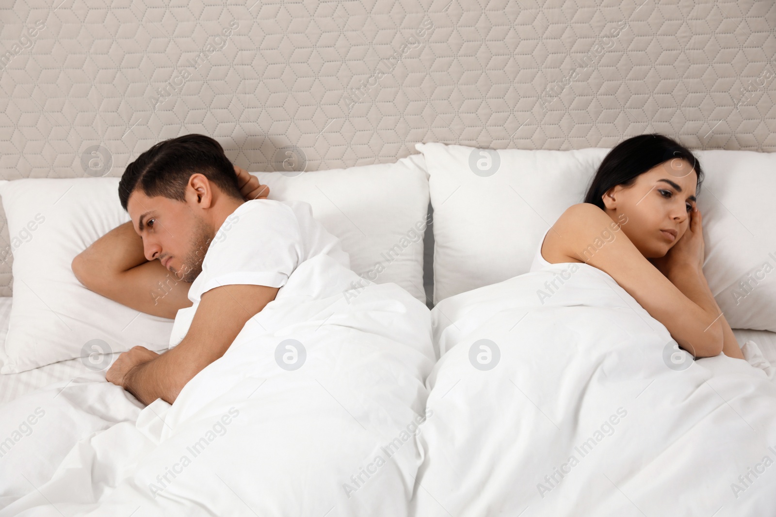 Photo of Unhappy couple with relationship problems after quarrel in bed