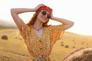 Photo of Portrait of beautiful happy hippie woman in field