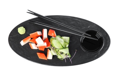 Photo of Fresh crab sticks with cucumber and soy sauce on white background, flat lay
