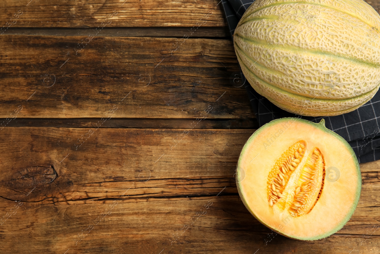 Photo of Tasty fresh melons on wooden table, flat lay. Space for text