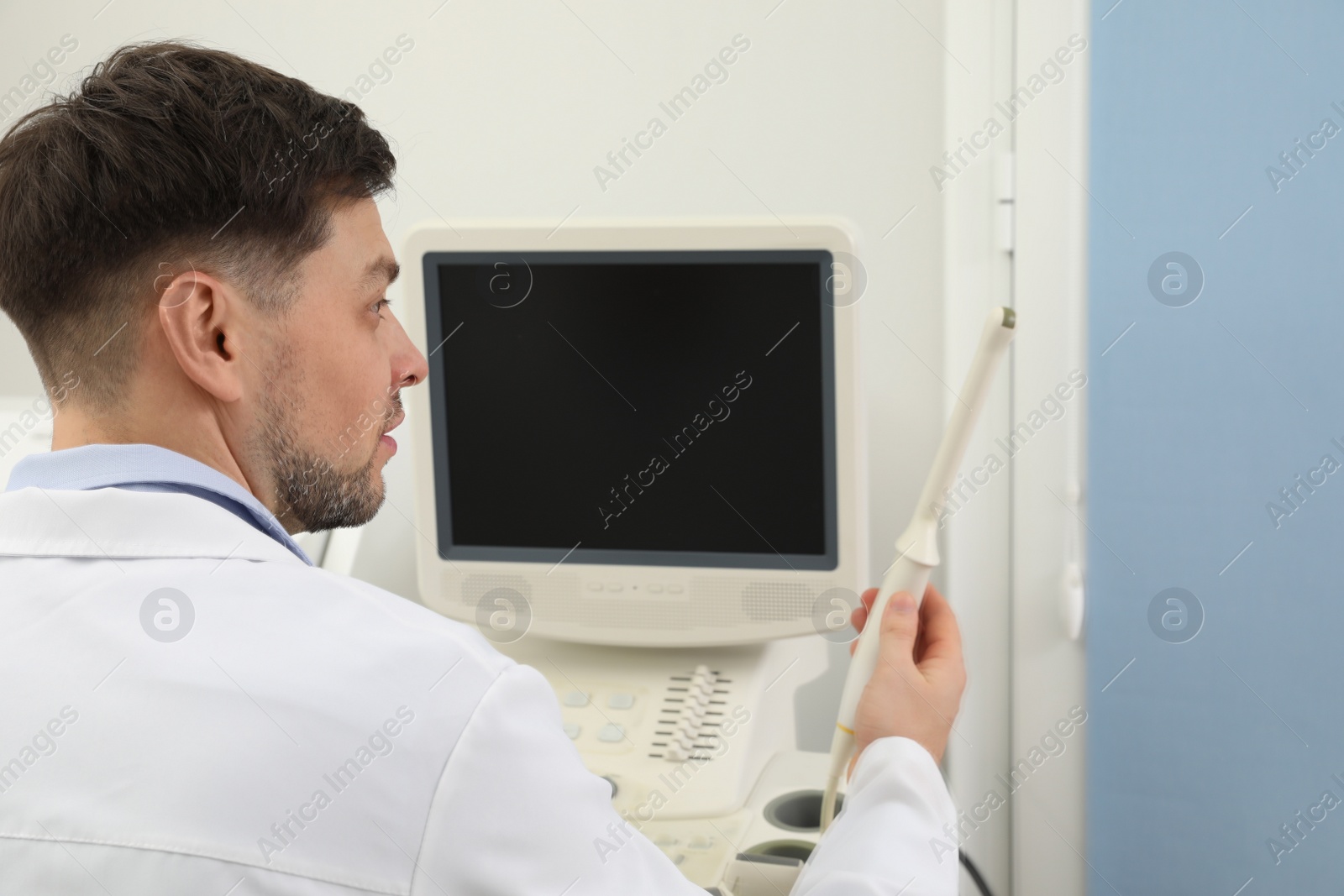 Photo of Professional sonographer using modern ultrasound machine in clinic