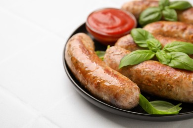 Photo of Plate with tasty homemade sausages, ketchup and basil leaves on white table, closeup. Space for text