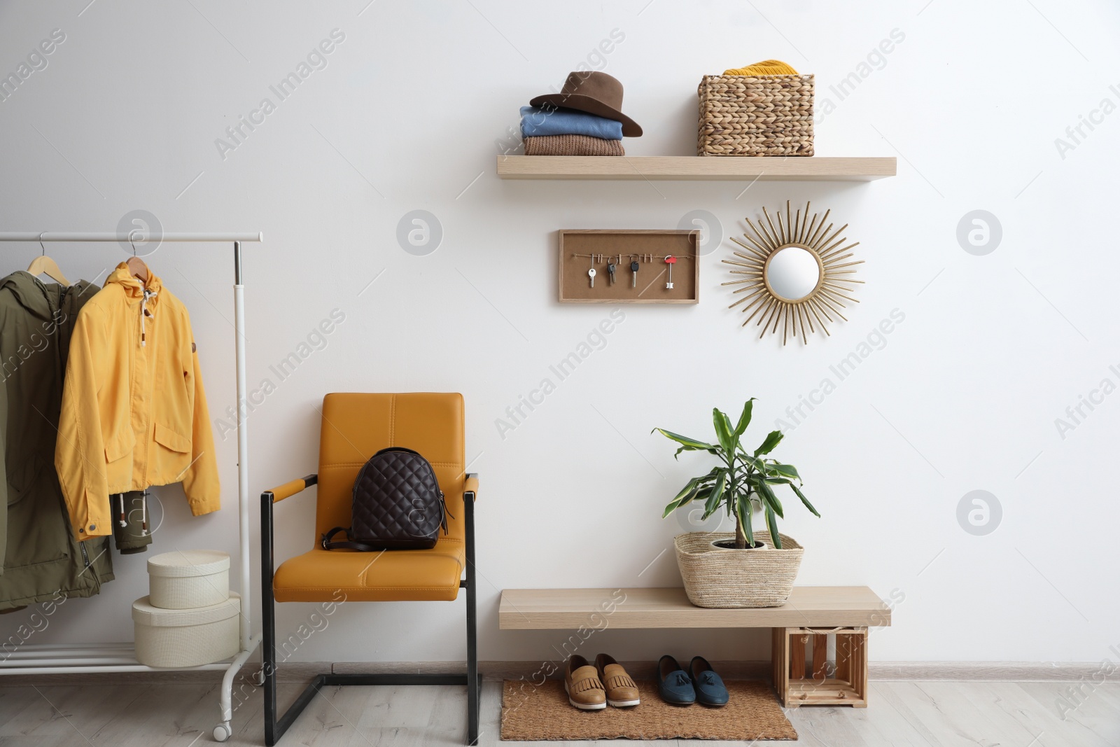 Photo of Hallway interior with stylish furniture, clothes and accessories
