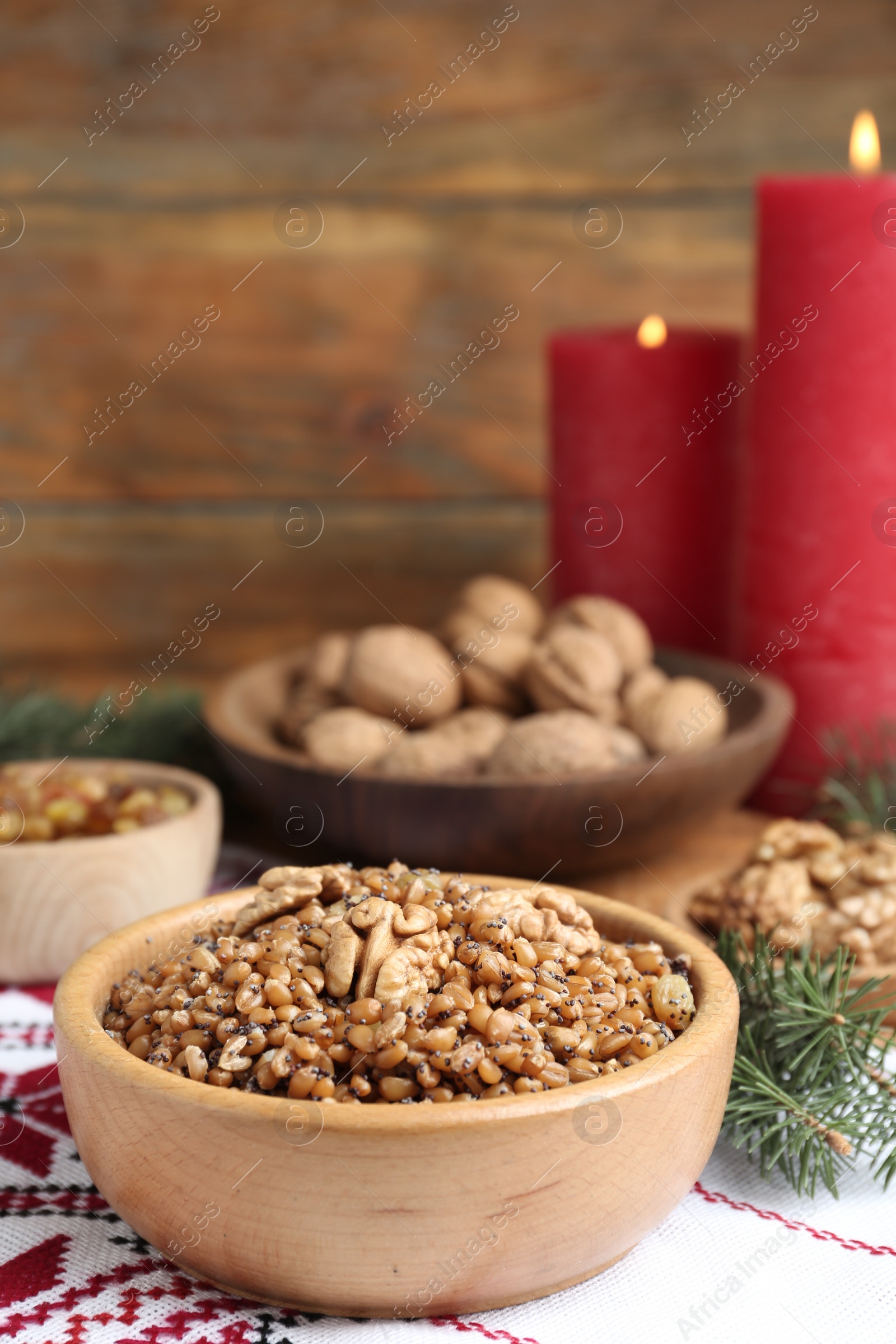 Photo of Traditional Christmas slavic dish kutia in bowl on rushnyk. Space for text