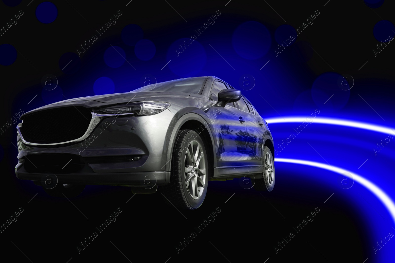 Image of Black modern car and speed light trails, motion blur and bokeh effect