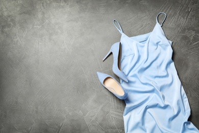 Photo of Stylish blue dress and shoes on grey background, flat lay. Space for text