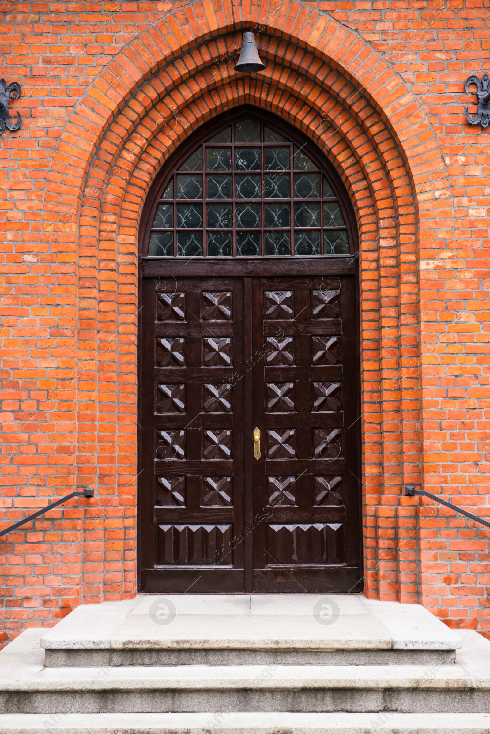 Photo of Entrance of building with beautiful arched wooden door