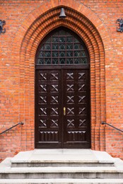 Entrance of building with beautiful arched wooden door