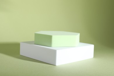Presentation of product. Podiums on light green background. Space for text