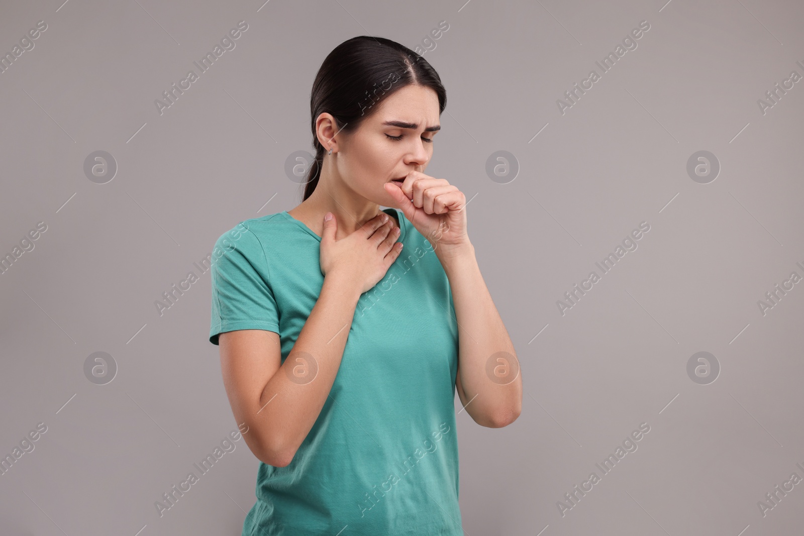 Photo of Woman coughing on grey background, space for text. Cold symptoms