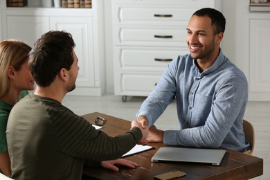 Photo of Notary shaking hands with client in office