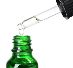 Photo of Bottle and pipette with essential oil on white background, closeup