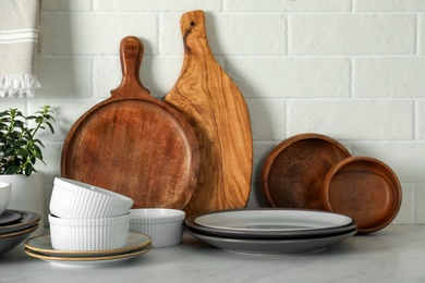 Photo of Set of clean tableware on white countertop in kitchen