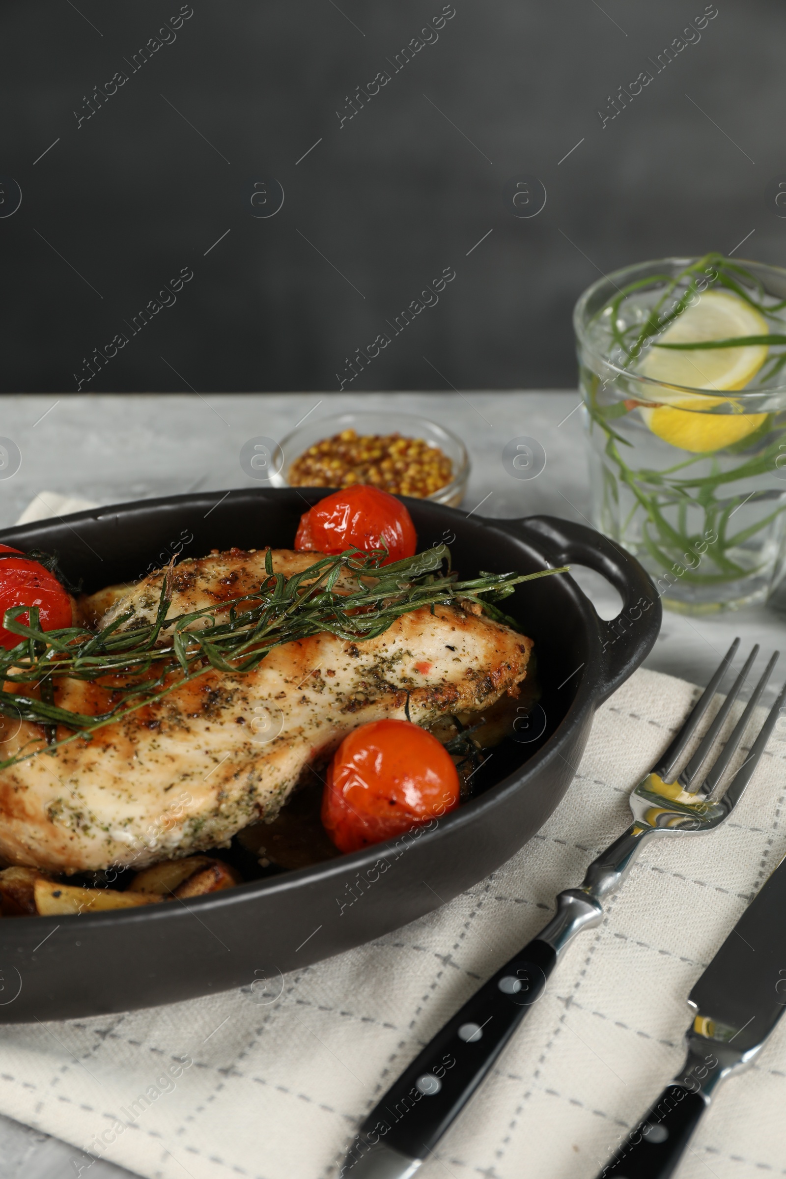Photo of Tasty chicken, vegetables, drink with tarragon and mustard served on grey table