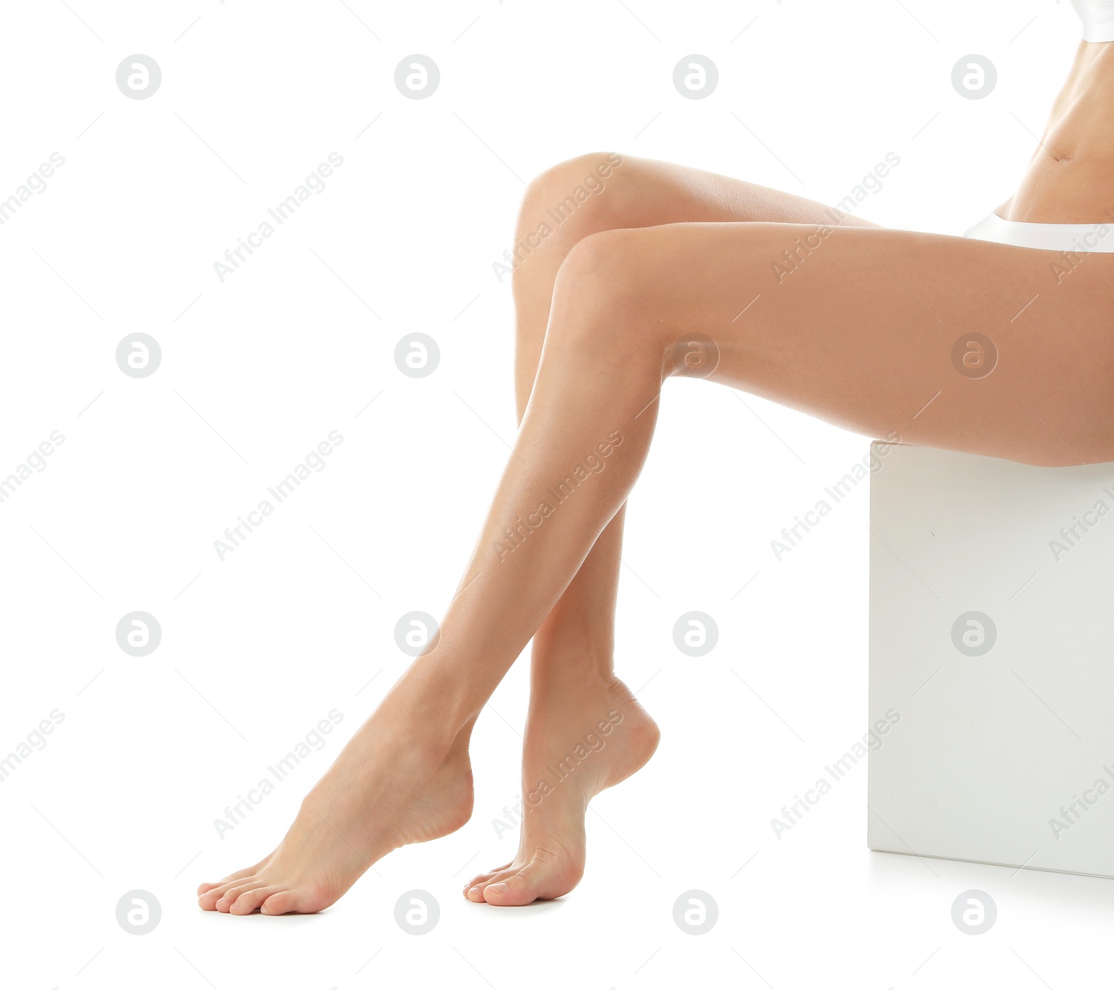 Photo of Young woman with beautiful long legs on white background, closeup