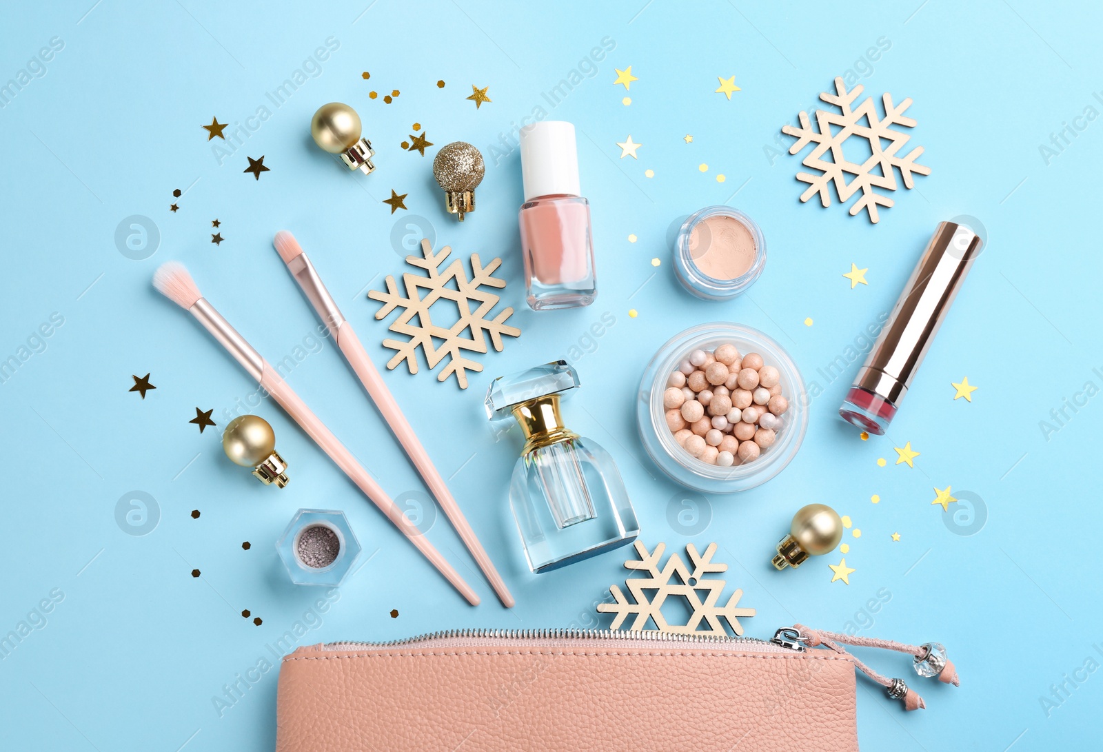 Photo of Flat lay composition with decorative cosmetic products on light blue background. Winter care