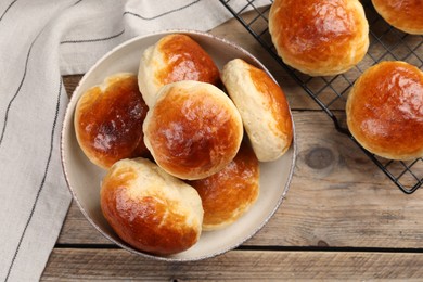 Photo of Tasty scones prepared on soda water on wooden table, flat lay