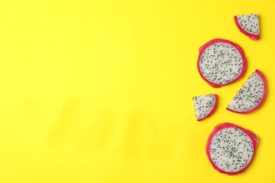Photo of Delicious sliced dragon fruit (pitahaya) on yellow background, flat lay. Space for text