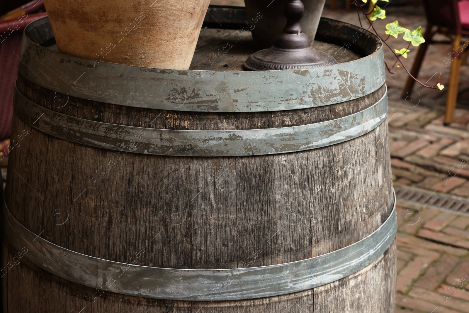 Photo of Traditional wooden barrel outdoors, closeup. Wine making