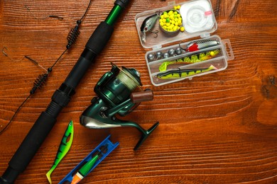 Photo of Fishing tackle on wooden table, flat lay. Space for text