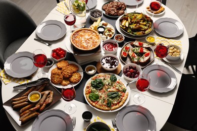 Photo of Brunch table setting with different delicious food indoors, above view